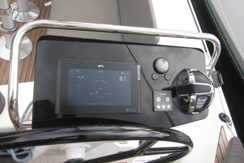 Slide: The Image of 2027 Jeanneau Sun Odyssey 455 helm with modern navigation controls and display. - 37