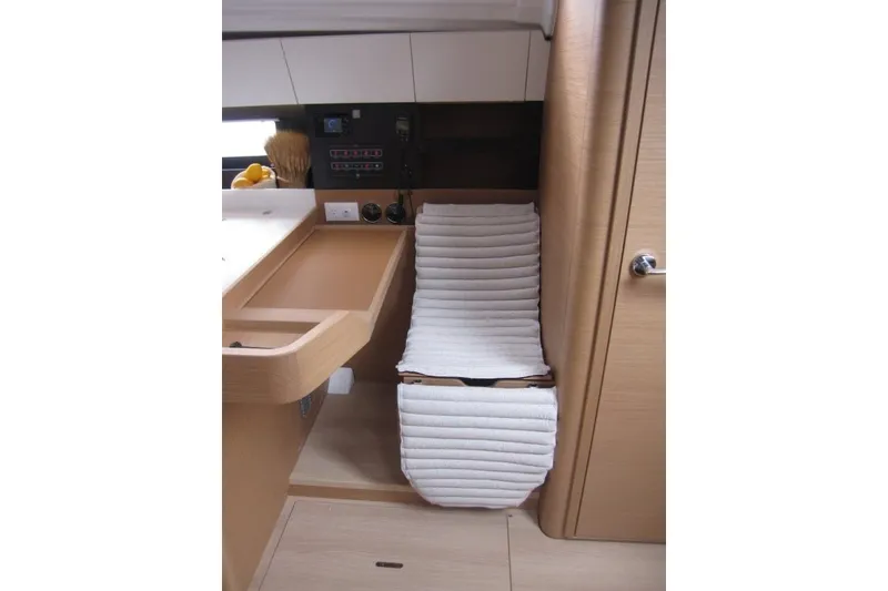 Slide: The Image of Interior of 2027 Jeanneau Sun Odyssey 455 yacht with modern design and cushioned seating. - 11