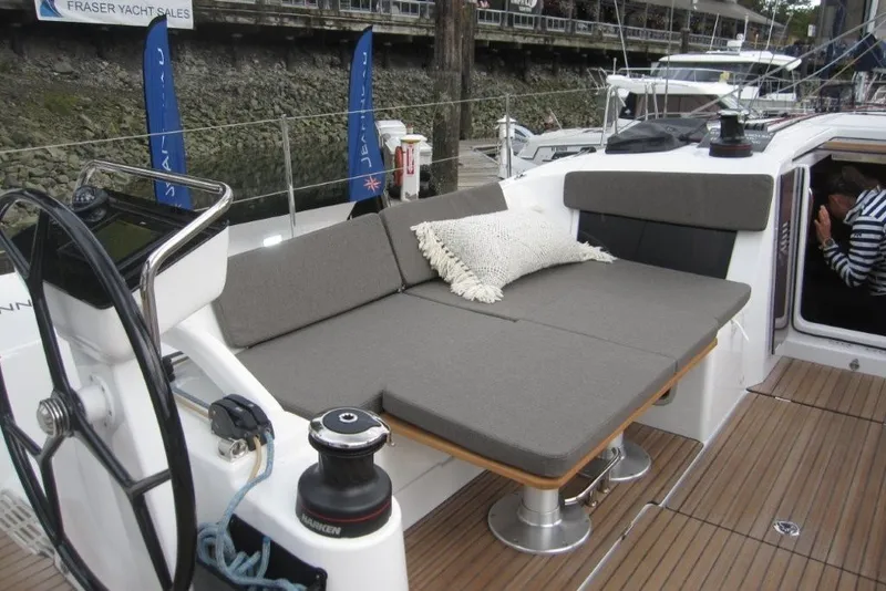 Slide: The Image of 2027 Jeanneau Sun Odyssey 455 yacht deck with cushioned seating and steering wheel. - 35
