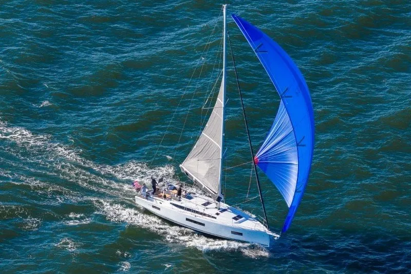 Slide: The Image of Sailing yacht Jeanneau Sun Odyssey 455 (2027) with blue spinnaker on open sea. - 48