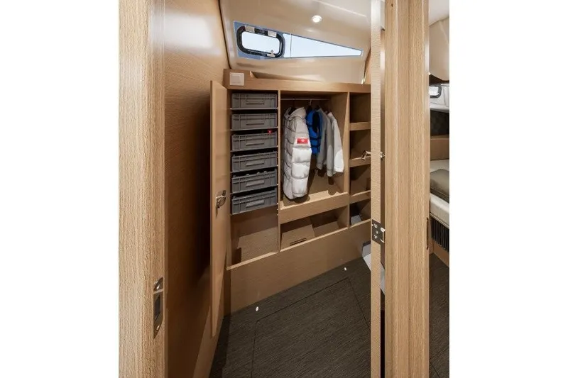 Slide: The Image of Interior of 2027 Jeanneau Sun Odyssey 455 yacht with wooden cabinetry and storage space. - 23