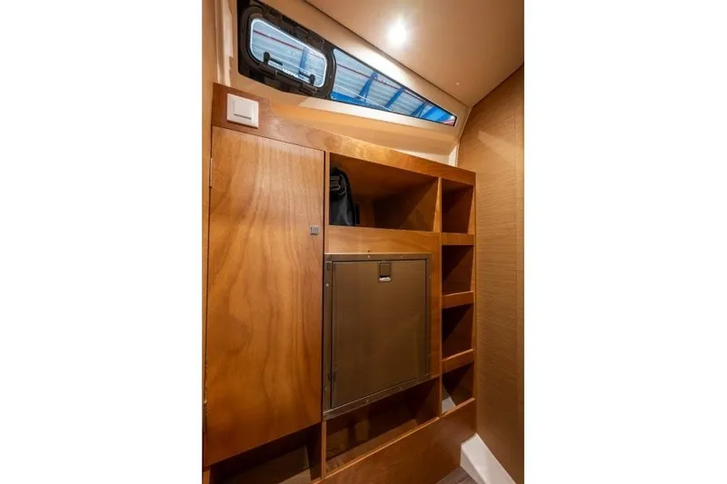 Slide: The Image of Interior storage area of 2027 Jeanneau Sun Odyssey 455 yacht with wooden cabinetry. - 24