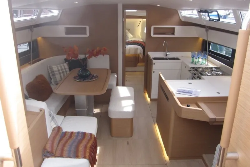 Slide: The Image of Luxurious interior of 2027 Jeanneau Sun Odyssey 455 yacht with modern kitchen and cozy seating area. - 1