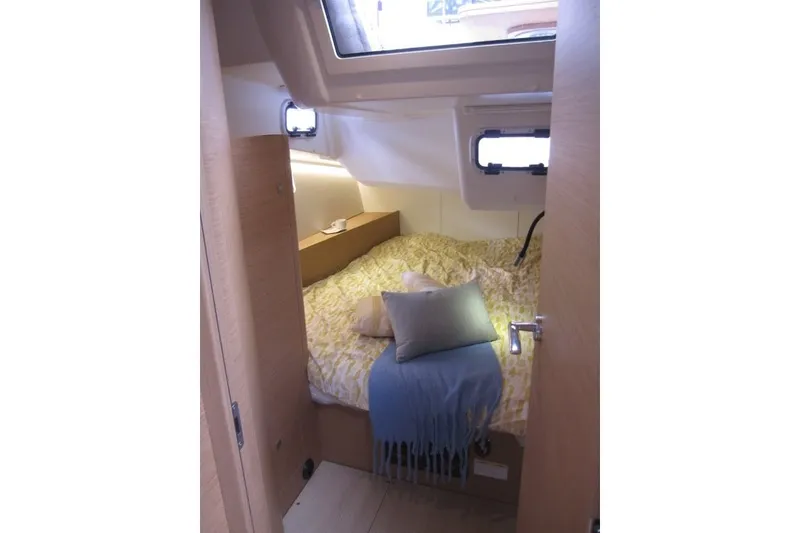 Slide: The Image of Cozy cabin interior of 2027 Jeanneau Sun Odyssey 455 sailboat with bed and window. - 21