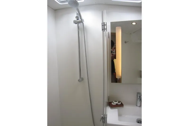 Slide: The Image of Modern bathroom in 2027 Jeanneau Sun Odyssey 455 yacht, featuring sleek shower and illuminated mirror. - 16