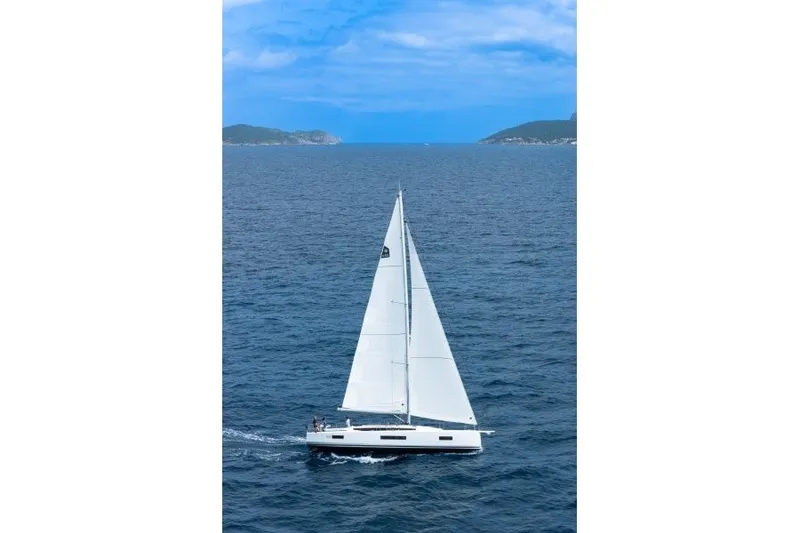 Slide: The Image of 2027 Jeanneau Sun Odyssey 455 sailing on open sea under clear blue sky. - 50