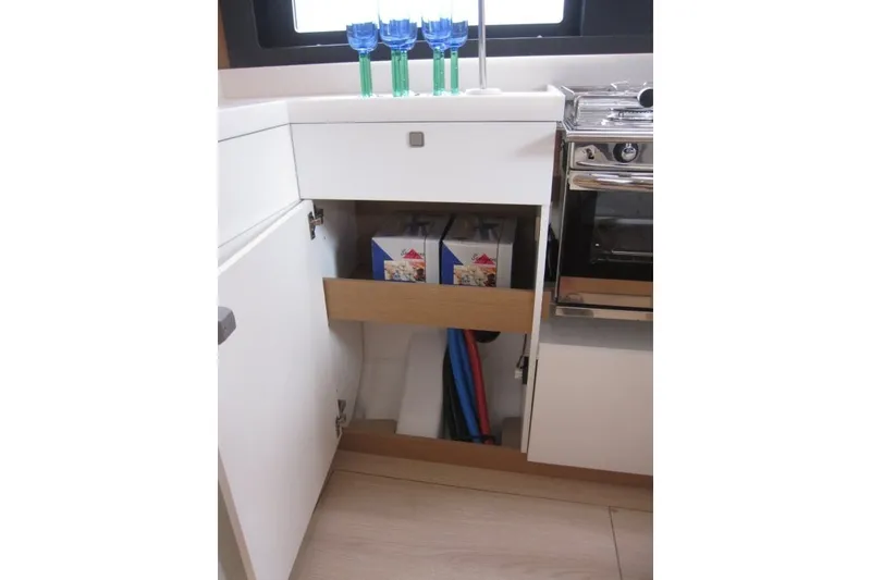 Slide: The Image of Modern kitchen interior of Jeanneau Sun Odyssey 455 yacht, featuring storage and appliances, 2027 model. - 7
