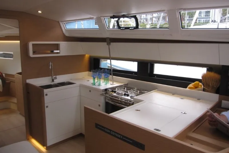 Slide: The Image of Modern kitchen interior of 2027 Jeanneau Sun Odyssey 455 yacht, featuring sleek design and amenities. - 5
