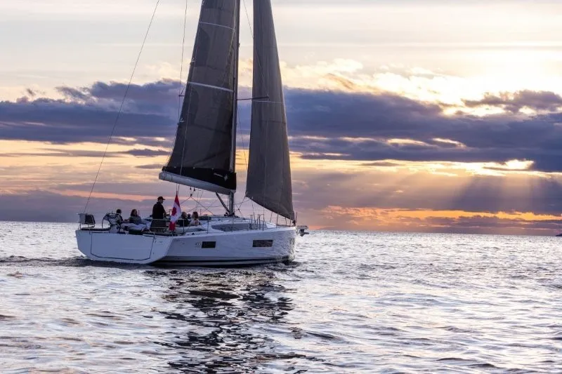 Slide: The Image of 2027 Jeanneau Sun Odyssey 455 sailing at sunset on calm waters. - 53