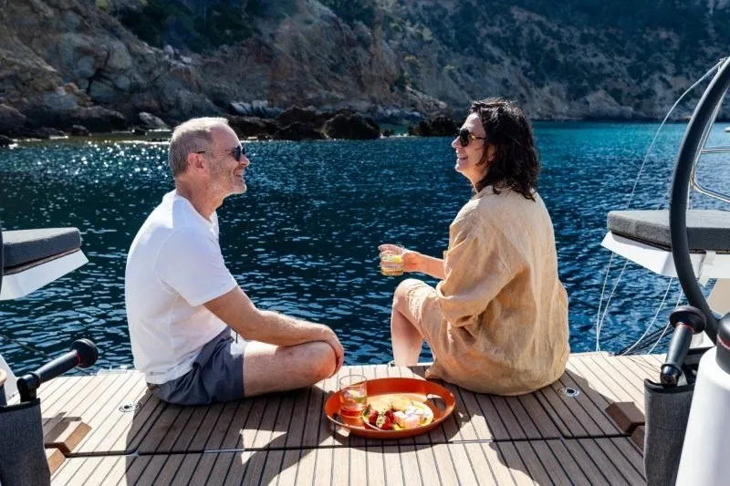 Slide: The Image of Couple enjoying drinks on Jeanneau Sun Odyssey 455 yacht, 2027, with scenic ocean view. - 55