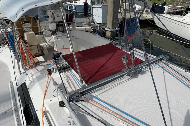 Slide: The Image of Catalina 310 sailboat, 2004 model, docked with visible rigging and cockpit area. - 8