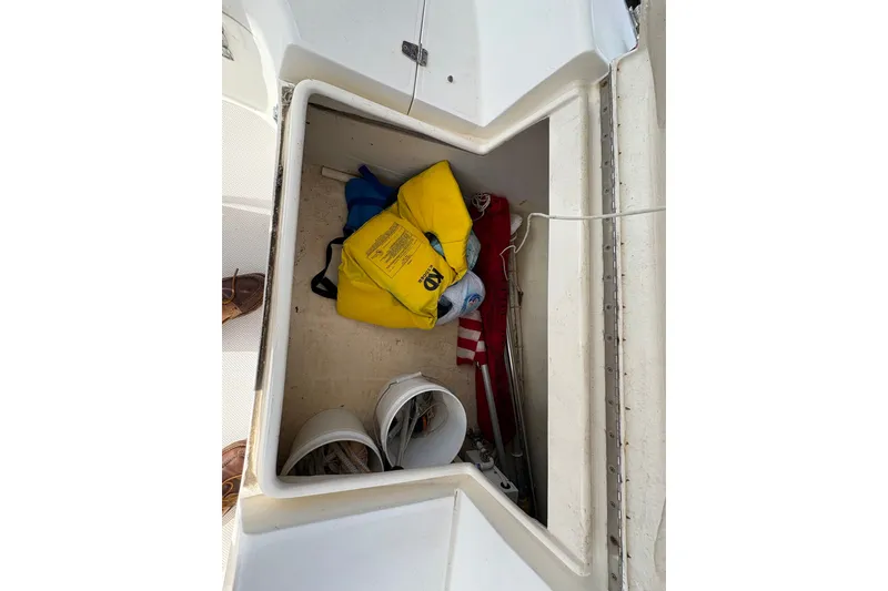 Slide: The Image of Storage compartment on a 2004 Catalina 310 sailboat with safety gear and equipment. - 12