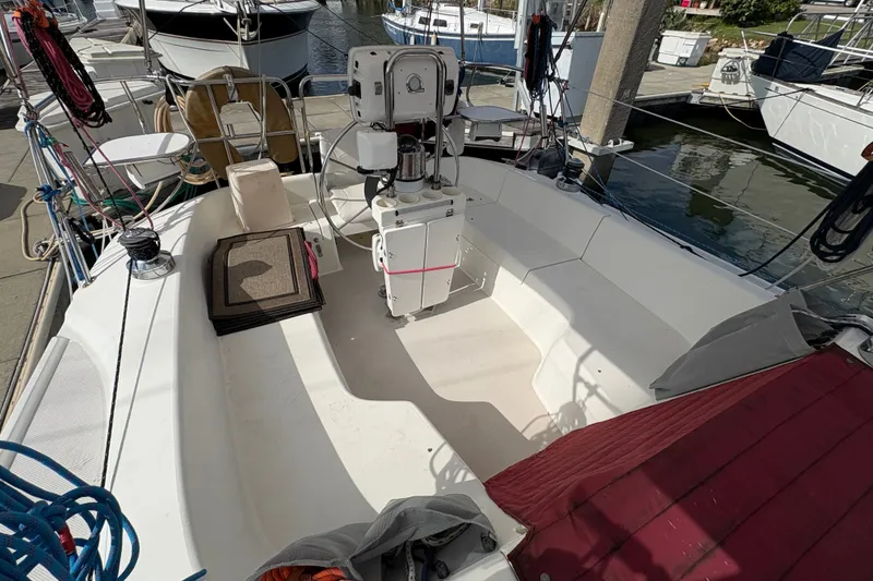 Slide: The Image of 2004 Catalina 310 sailboat cockpit with steering wheel, docked at marina. - 9