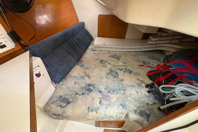 Slide: The Image of Interior cabin of a 2004 Catalina 310 sailboat with cushions and storage. - 18