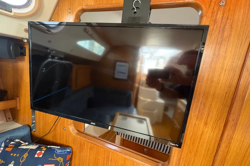 Slide: The Image of Flat-screen TV mounted inside a 2004 Catalina 310 sailboat cabin. - 27