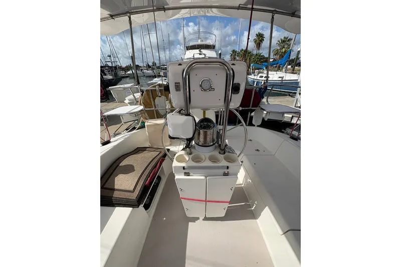 Slide: The Image of Cockpit of 2004 Catalina 310 sailboat with steering wheel and seating area. - 10