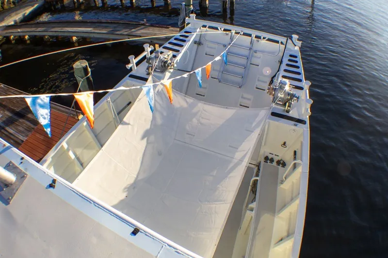 Slide: The Image of Aerial view of 2013 Silver Ships Inc Barrows 60 boat docked, featuring deck and colorful flags. - 6