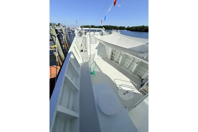 Slide: The Image of 2013 Silver Ships Inc Barrows 60 boat deck, docked with clear sky and water view. - 5