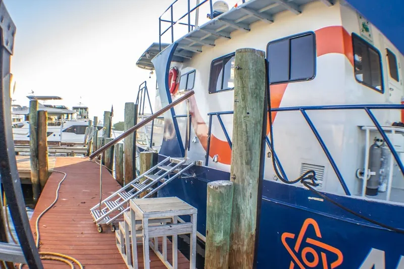 Slide: The Image of 2013 Silver Ships Inc Barrows 60 docked with boarding ladder and wooden pier. - 3