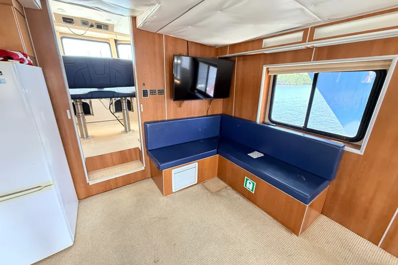 Slide: The Image of Interior of 2013 Silver Ships Inc Barrows 60 with seating, TV, and window view. - 14