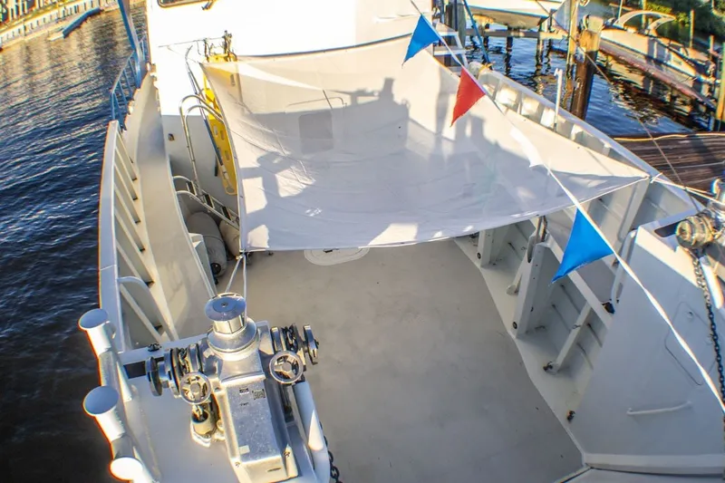 Slide: The Image of Deck view of 2013 Silver Ships Inc Barrows 60 boat with canopy and colorful flags. - 9