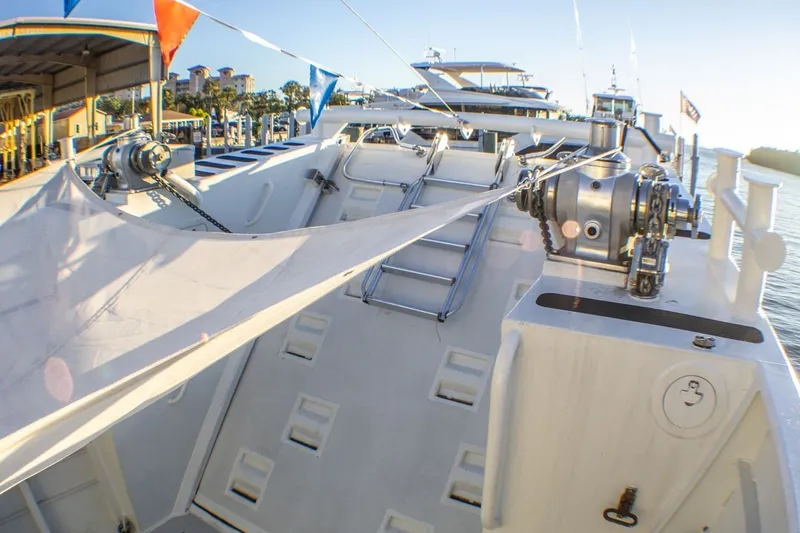 Slide: The Image of 2013 Silver Ships Inc Barrows 60 boat deck with winches and colorful flags. - 8