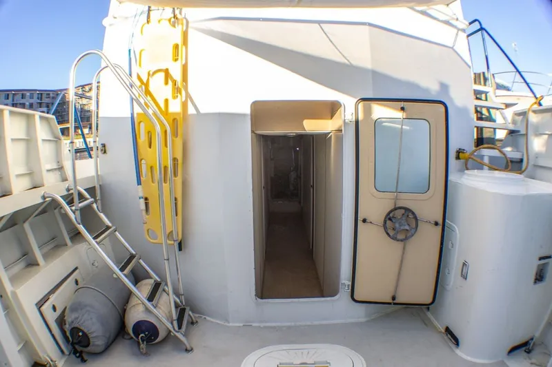 Slide: The Image of Exterior view of 2013 Silver Ships Inc Barrows 60 vessel with open door and ladder. - 12