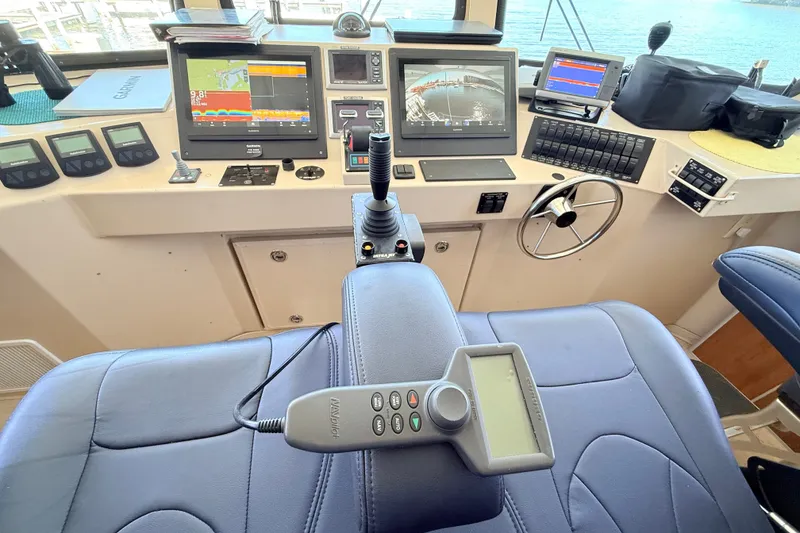 Slide: The Image of Control panel of 2013 Silver Ships Inc Barrows 60 with navigation screens and steering wheel. - 27