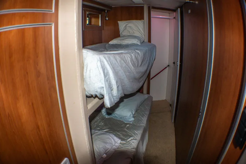 Slide: The Image of Interior of 2013 Silver Ships Inc Barrows 60 with wooden bunk beds and cozy bedding. - 18