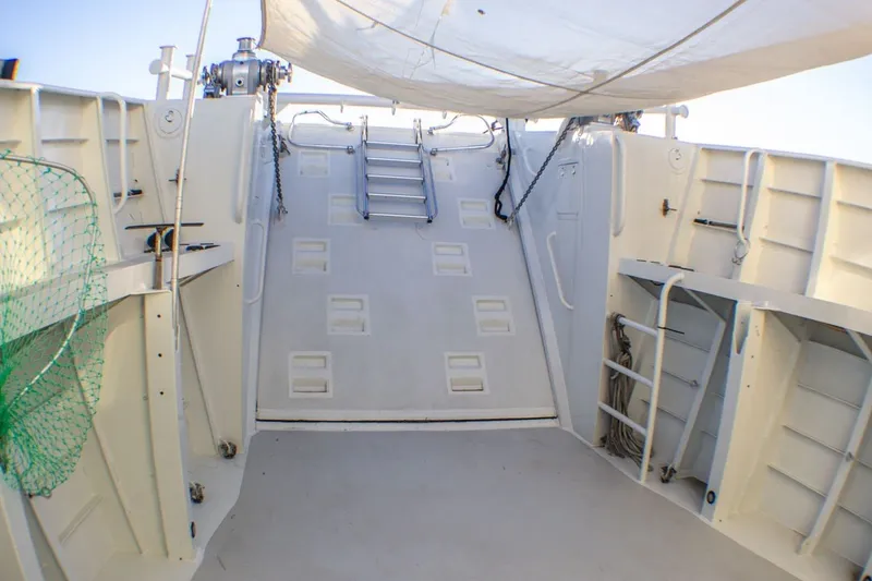 Slide: The Image of Interior view of 2013 Silver Ships Inc Barrows 60 boat, featuring a clean, white deck area. - 10