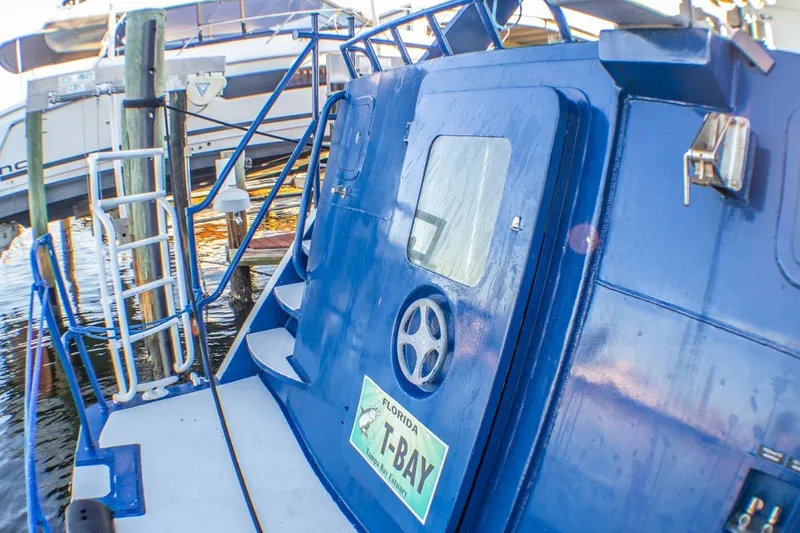 Slide: The Image of Blue Silver Ships Inc Barrows 60 boat docked, featuring Florida T-Bay license plate. - 2