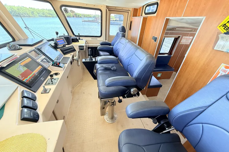Slide: The Image of Interior of 2013 Silver Ships Inc Barrows 60, featuring navigation equipment and blue seating. - 26