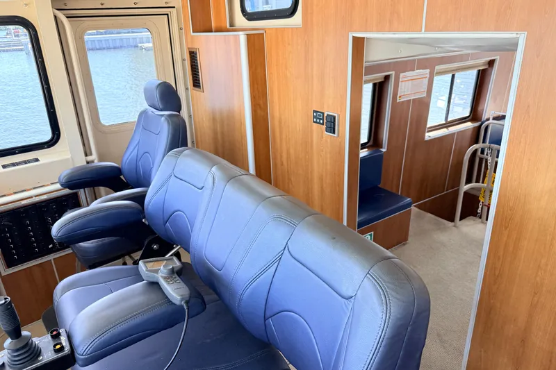 Slide: The Image of Interior of 2013 Silver Ships Inc Barrows 60, featuring blue seating and wood paneling. - 29