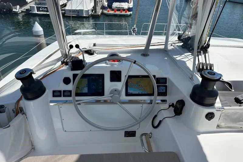 Slide: The Image of Helm of 2023 Bali 4.4 catamaran with navigation screens and steering wheel in marina. - 36