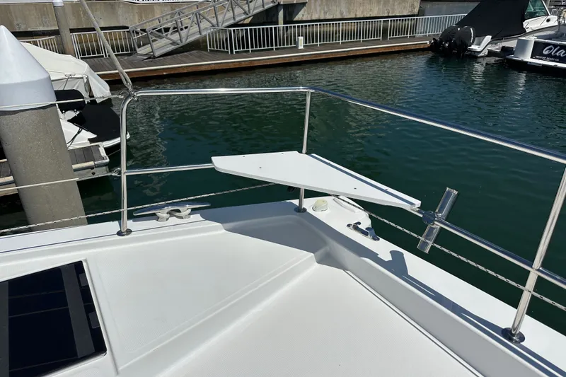 Slide: The Image of Bow of 2023 Bali 4.4 yacht docked at marina, featuring sleek railing and water view. - 26