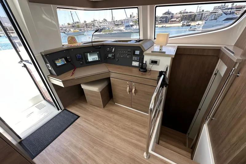 Slide: The Image of Modern helm station on 2023 Bali 4.4 yacht with navigation equipment and marina view. - 61