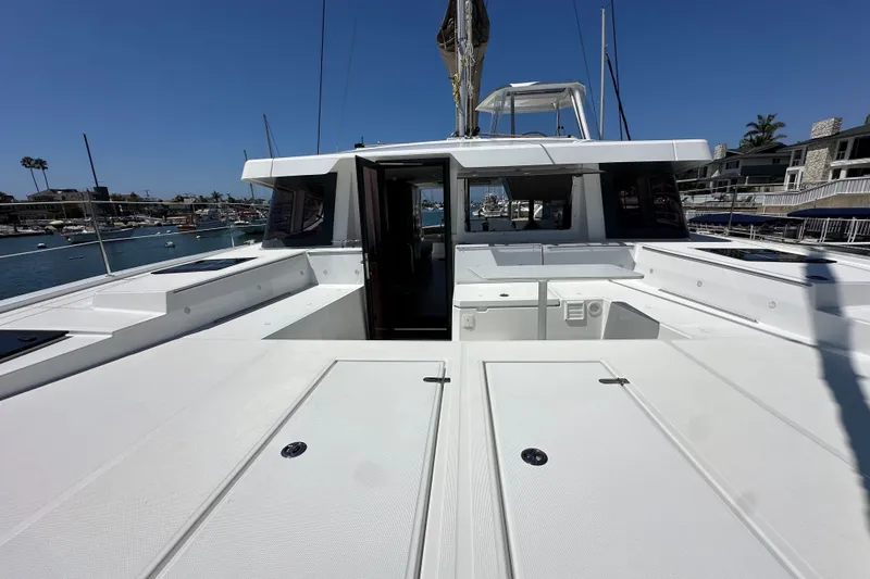 Slide: The Image of 2023 Bali 4.4 catamaran docked in marina, showcasing spacious deck and modern design. - 24