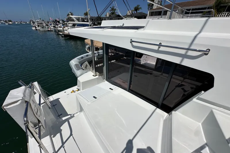 Slide: The Image of Modern 2023 Bali 4.4 yacht docked at marina, showcasing sleek design and spacious deck. - 50