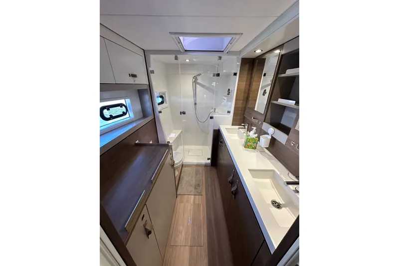 Slide: The Image of Modern bathroom interior in 2023 Bali 4.4 model yacht, featuring dual sinks and shower. - 77