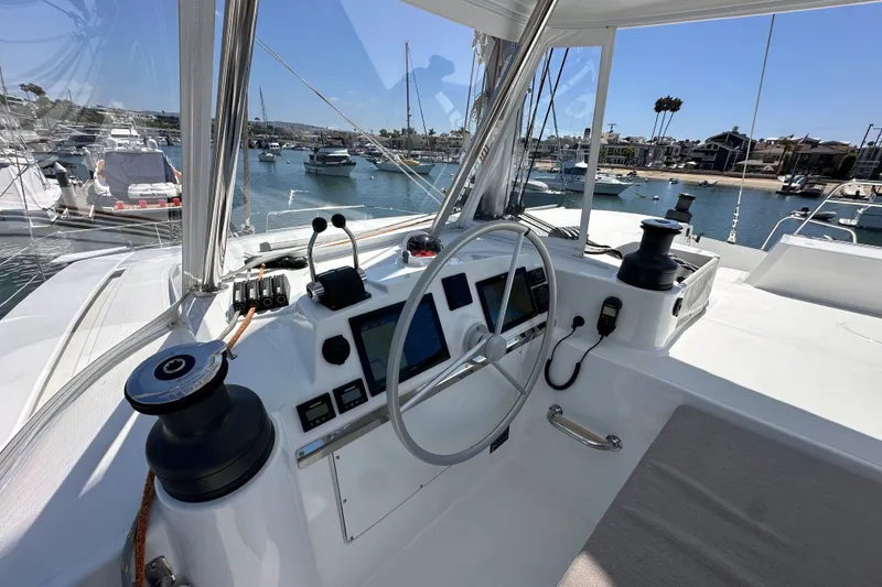 Slide: The Image of Helm of 2023 Bali 4.4 catamaran with marina view, featuring modern navigation equipment. - 33