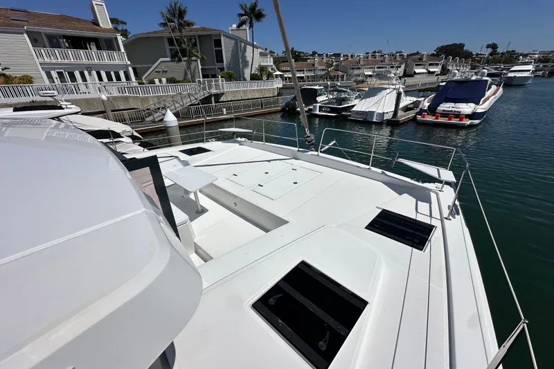 Slide: The Image of Modern 2023 Bali 4.4 yacht docked in a marina with waterfront homes. - 21