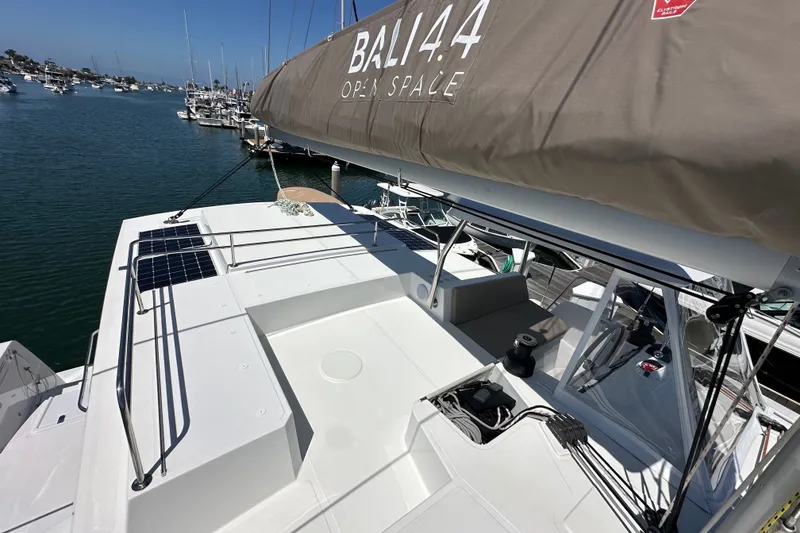 Slide: The Image of 2023 Bali 4.4 catamaran docked at marina, showcasing open deck and solar panels. - 45