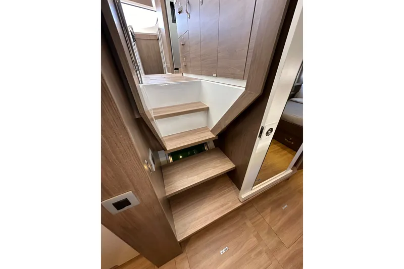 Slide: The Image of Modern wooden staircase in 2023 Bali 4.4 model interior, featuring sleek design and storage. - 86