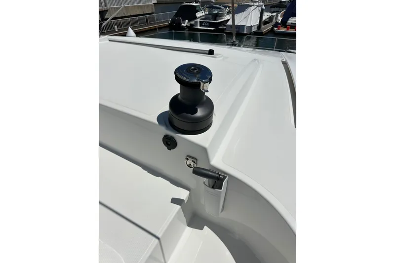 Slide: The Image of Deck view of a 2023 Bali 4.4 yacht, featuring a winch and sleek design. - 49
