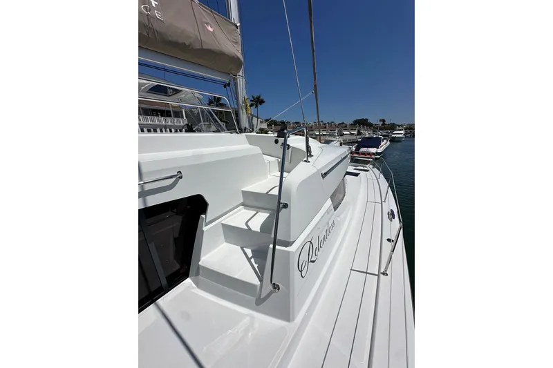 Slide: The Image of 2023 Bali 4.4 yacht docked, showcasing sleek white deck and modern design. - 19