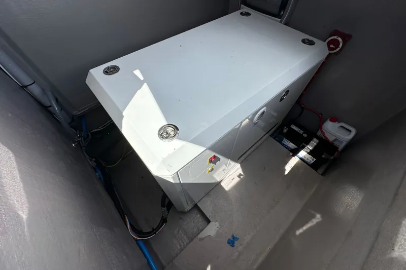 Slide: The Image of Electrical compartment of a 2023 Bali 4.4 model, featuring wiring and battery setup. - 115