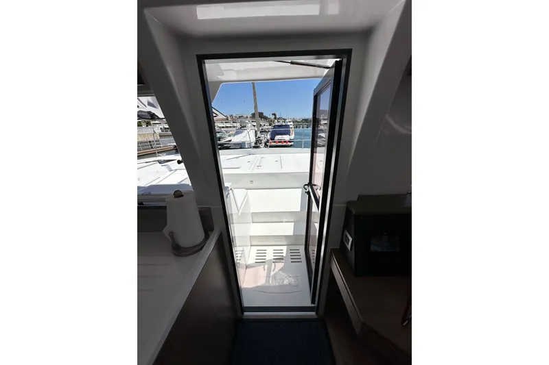 Slide: The Image of Interior view of a 2023 Bali 4.4 yacht, showing a doorway leading to the deck. - 66