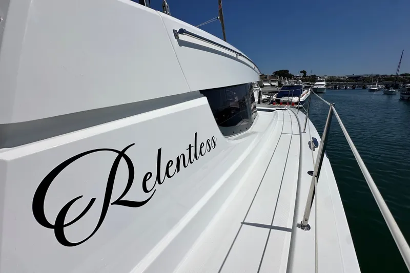 Slide: The Image of 2023 Bali 4.4 yacht named "Relentless" docked in a marina under clear skies. - 20