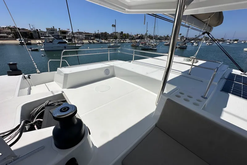 Slide: The Image of Spacious deck of 2023 Bali 4.4 catamaran in a sunny marina setting. - 44