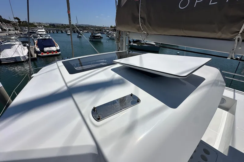 Slide: The Image of Modern Bali 4.4 yacht deck, 2023 model, docked in a marina with other boats. - 34